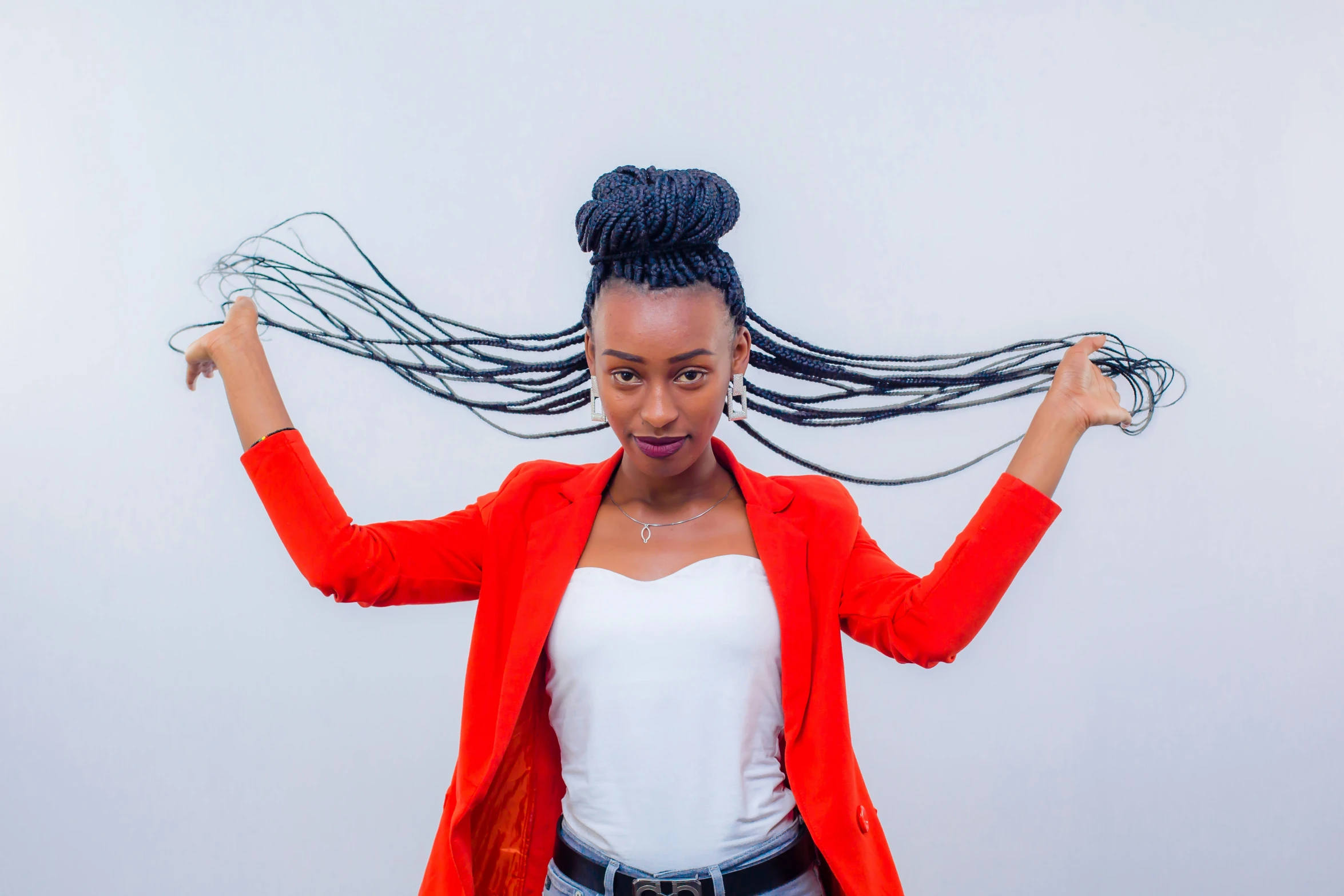 a woman with long, black hair standing in front of white background