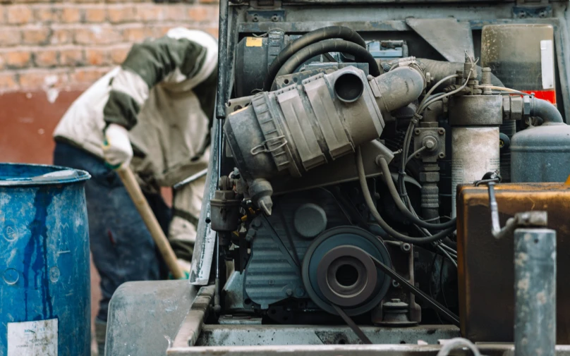 a man with a duster cleaning a truck