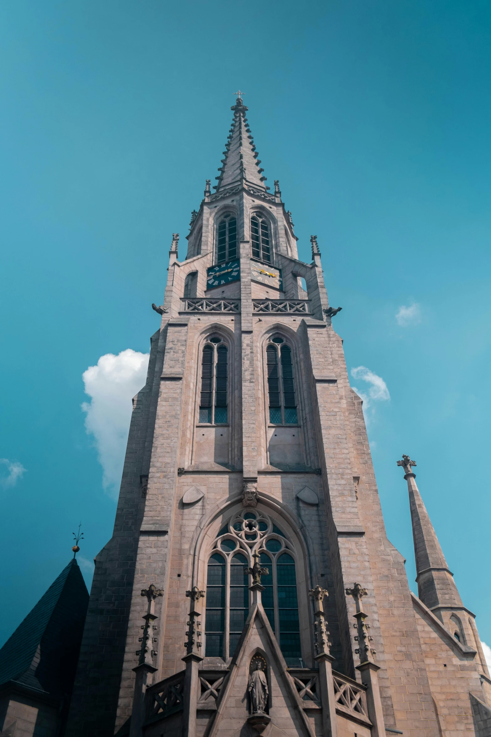 the spire of a building has a clock on it