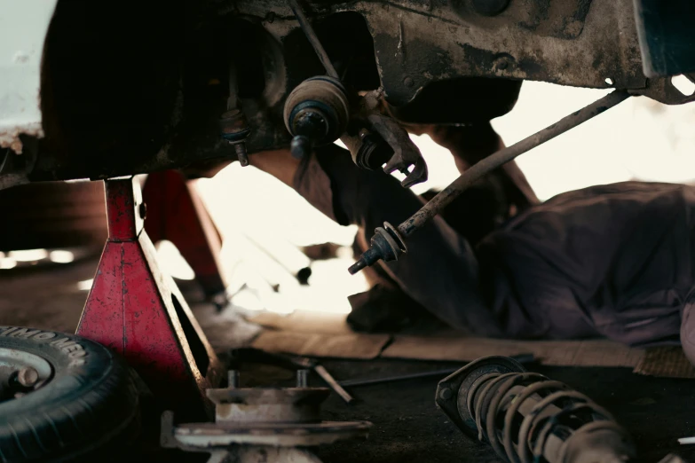 a person is working on a red object in a garage