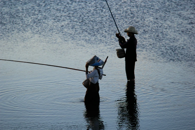 two people standing in water on their backs