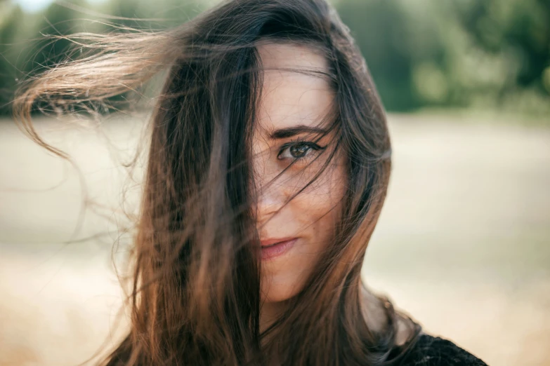 a woman standing outdoors looking off into the distance