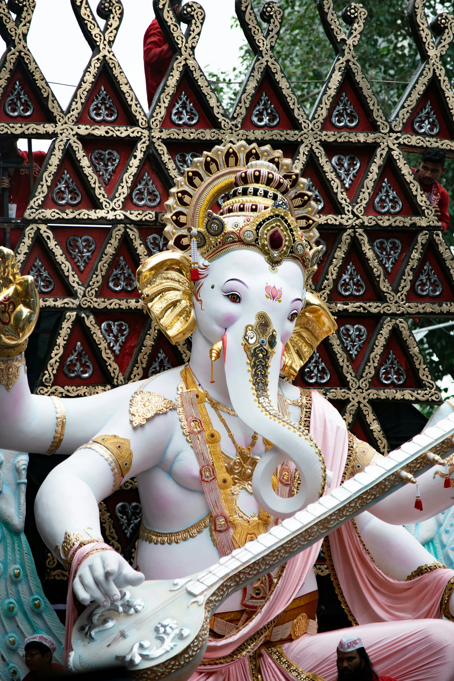 the statue of an elephant is covered in gold and silver