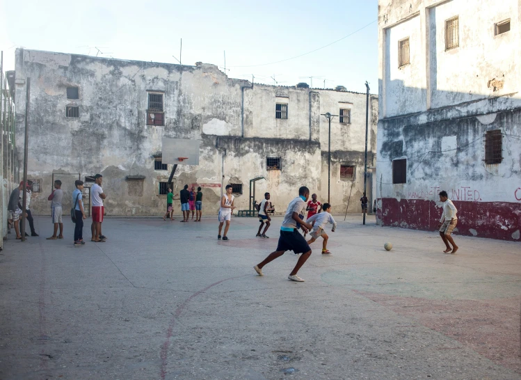 several people playing basketball while one man throws the ball