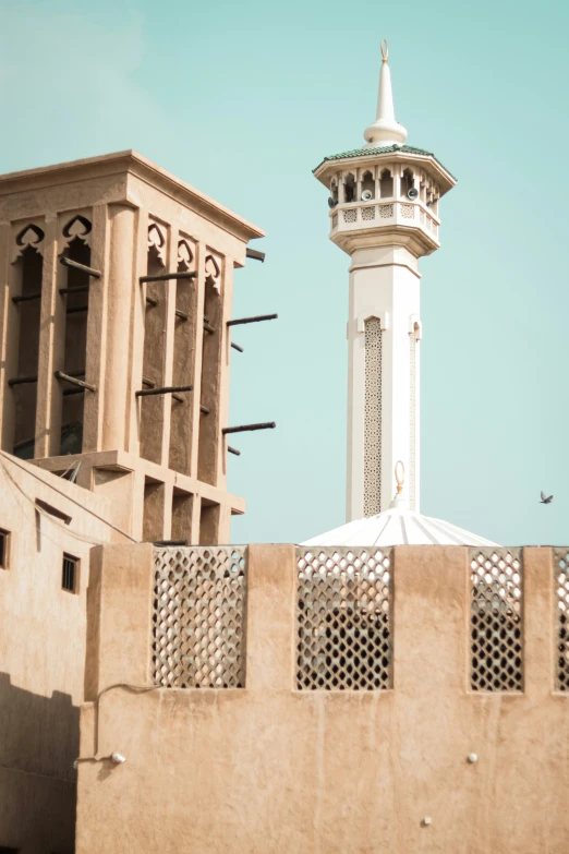 a tall building and a tower sit side by side