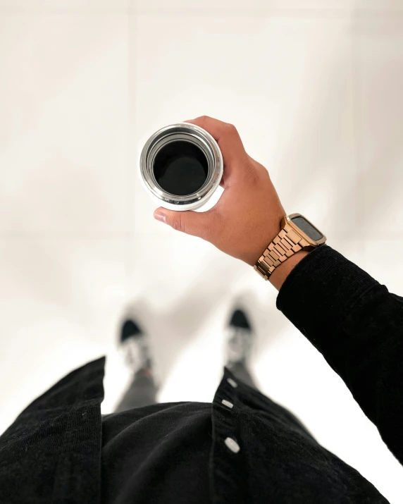 a man in black sweater holding up a camera