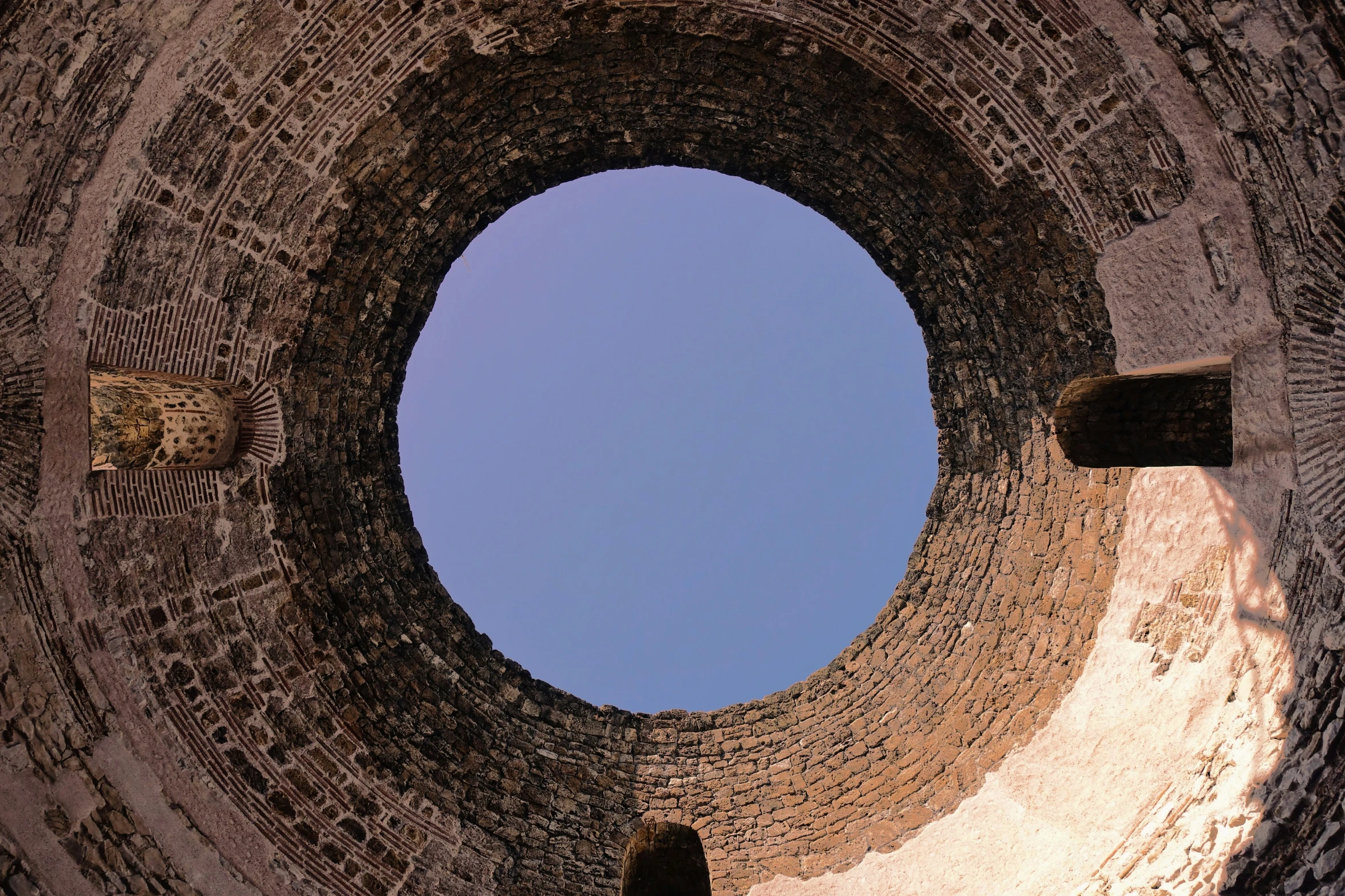 an image of the bottom part of a stone tower