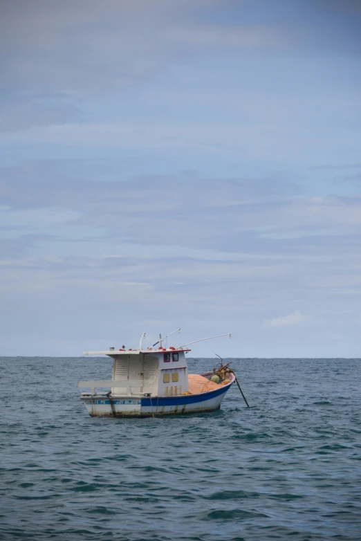 a small boat floating on top of a large body of water