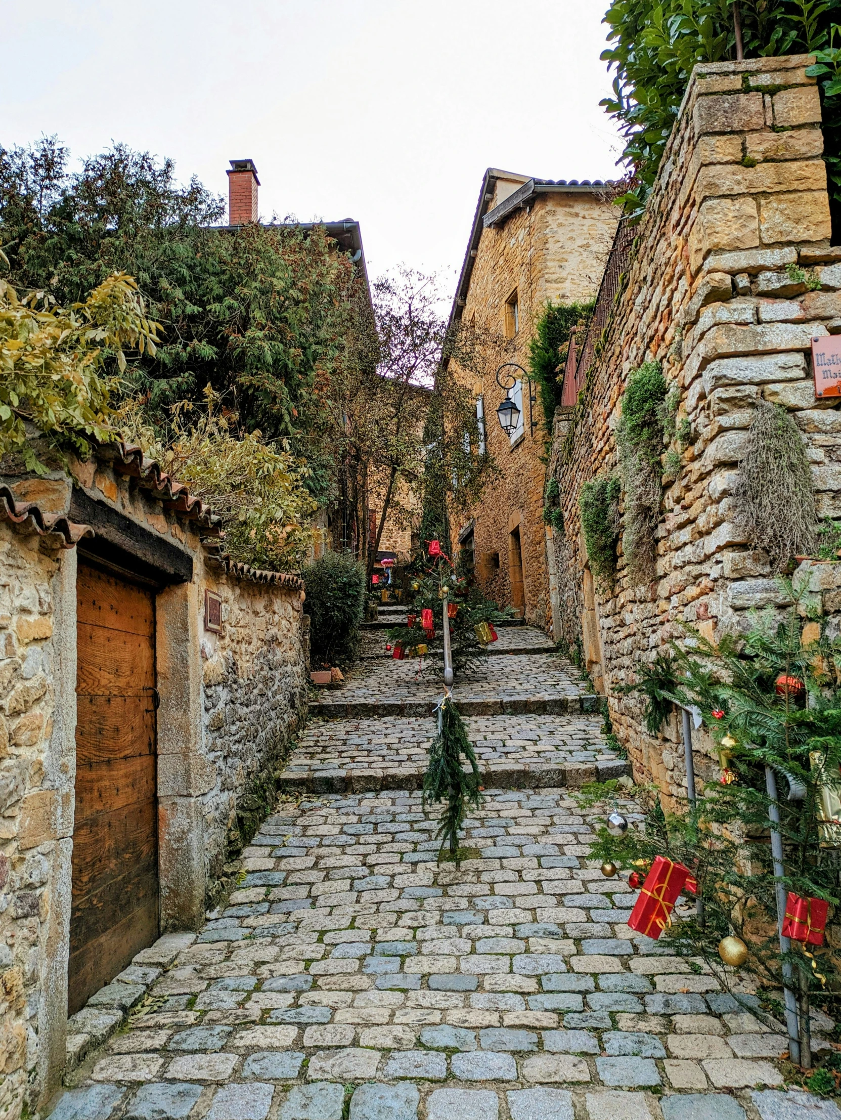 a cobblestone path between two old brick buildings