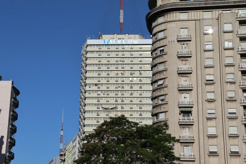 a tall building next to two smaller buildings