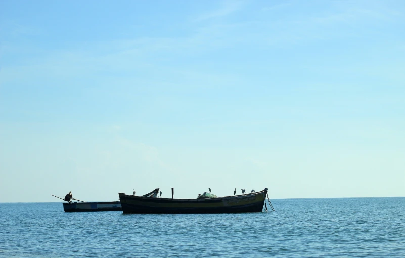 the boat is in the water with a blue sky