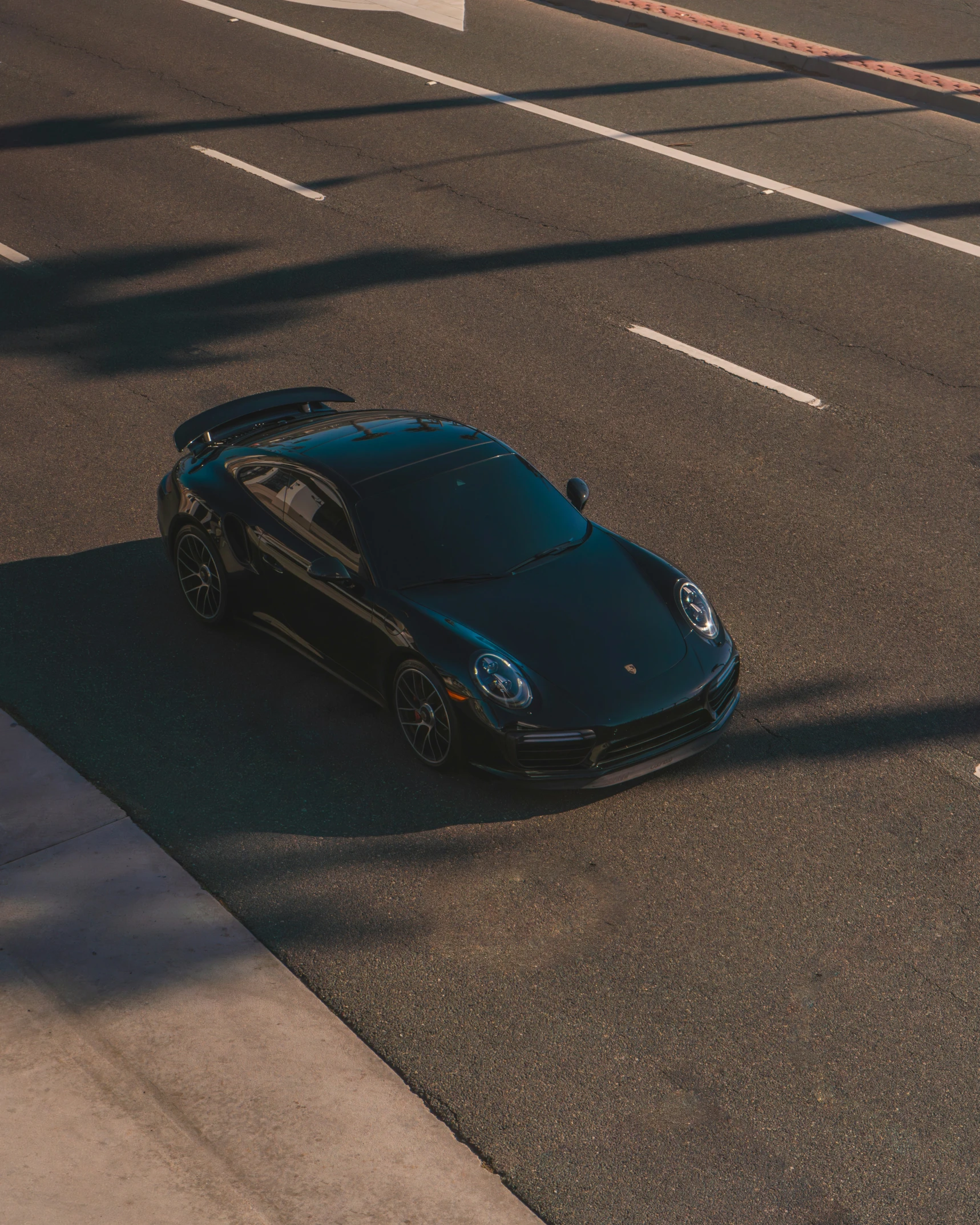 a black sports car parked on the side of a street