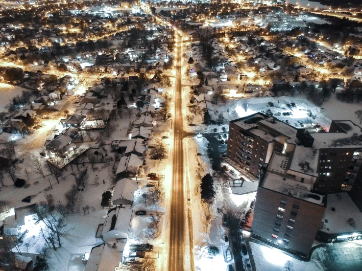 a snowy cityscape at night and light from above