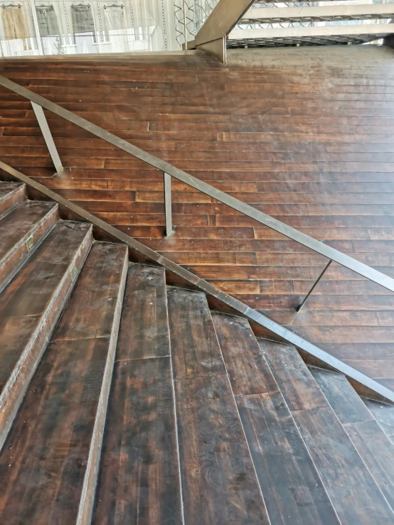 the wood flooring with a metal banister and handrail