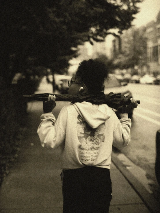 a person walking down a street with a gun in their hand