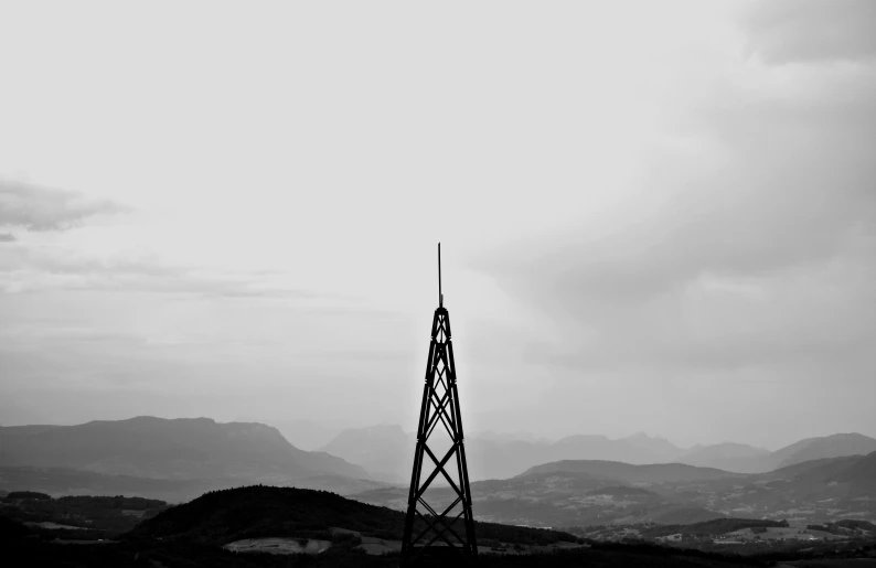 the plane is flying by a tower in the sky