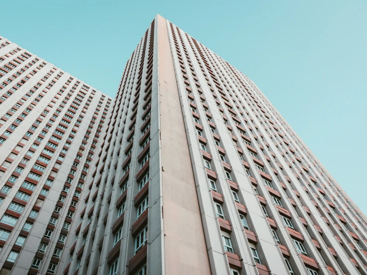 looking up at tall buildings from below, on a bright day