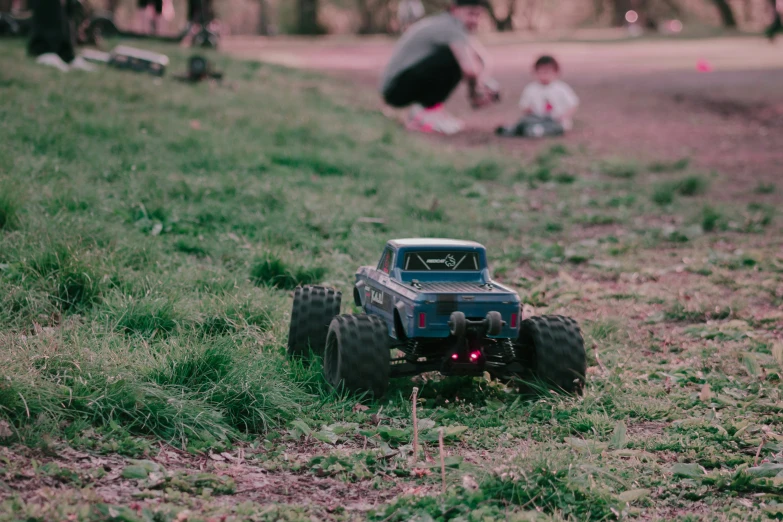 a toy truck on the ground in a field