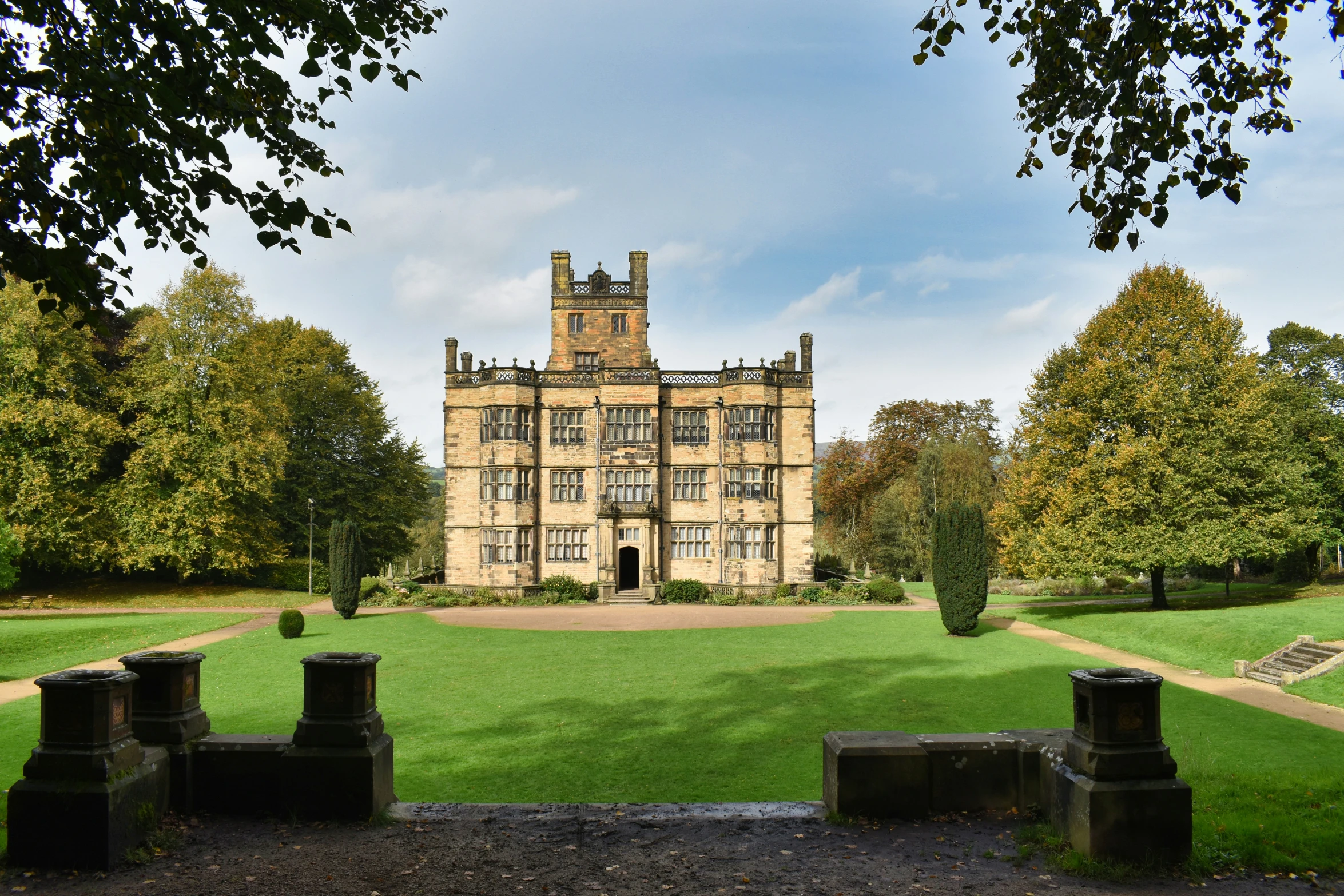 a very big nice old mansion by some grass