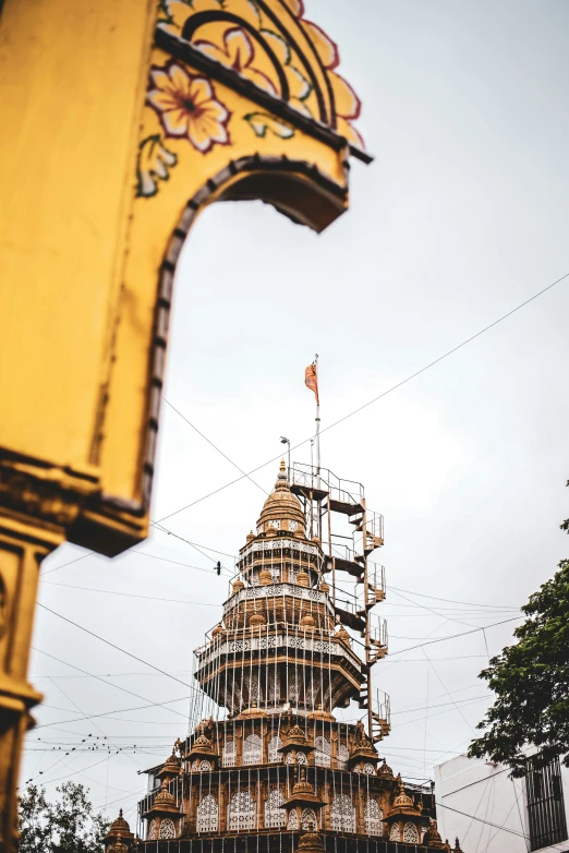 a tall tower with a small flag on top of it