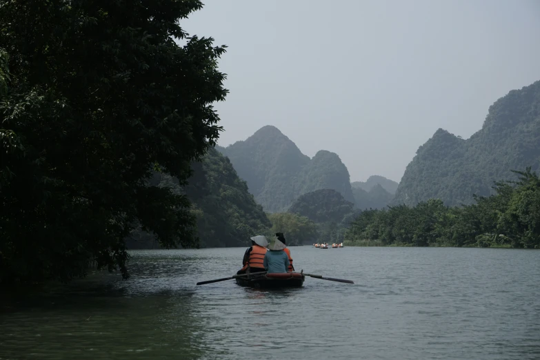 two people in a row boat on the water