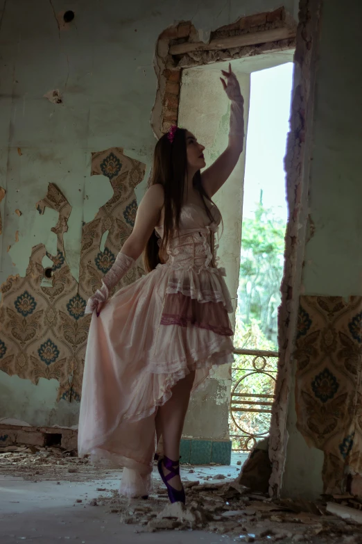 a woman in a pink dress and purple shoes stands in a destroyed building