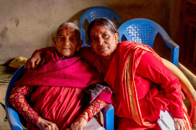 two people sitting next to each other