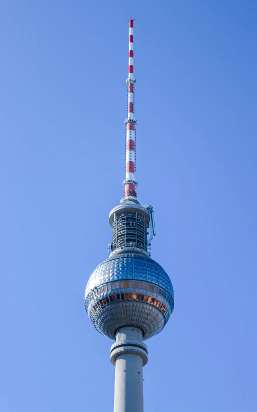 a tall tower has a radio and lights on it