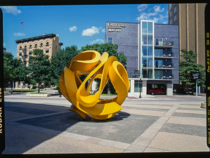 the statue in the middle of the street is yellow