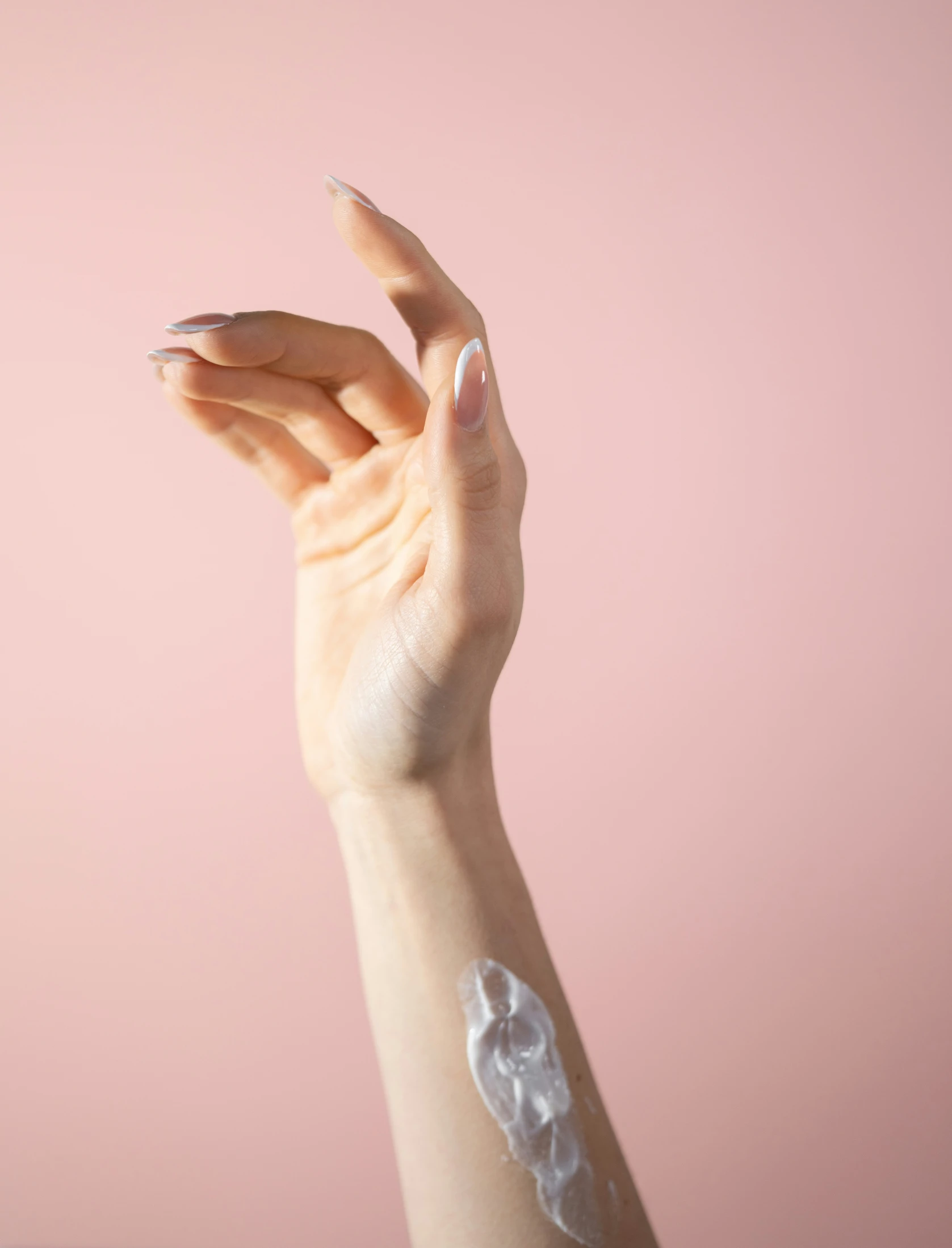 woman's hand with manicured nails and nail decals