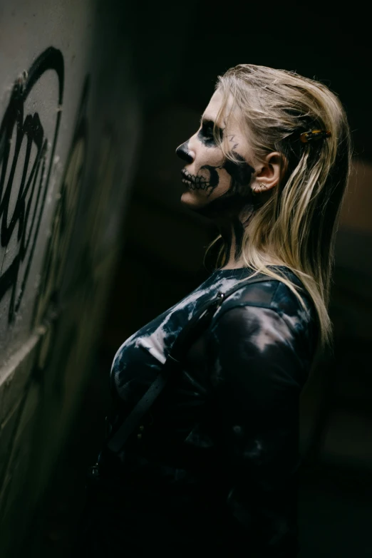 woman with makeup holding the knife and  the wall