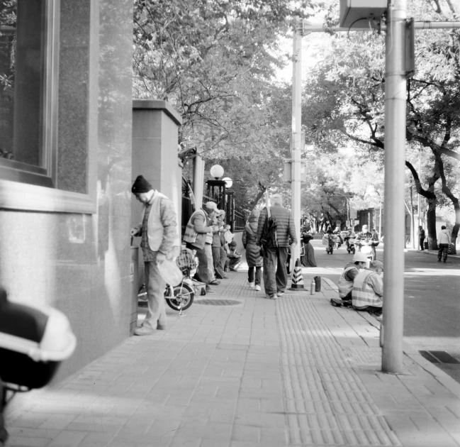 a man on a sidewalk in the city with many s