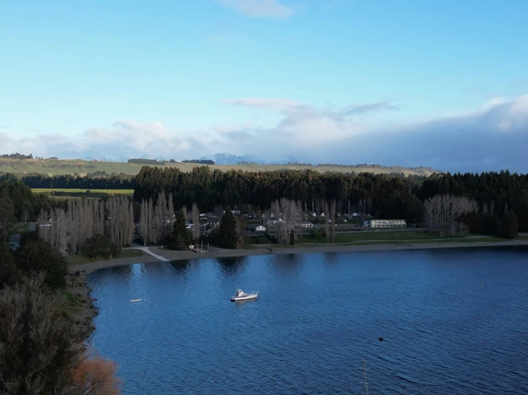 a small boat floating in the middle of a lake