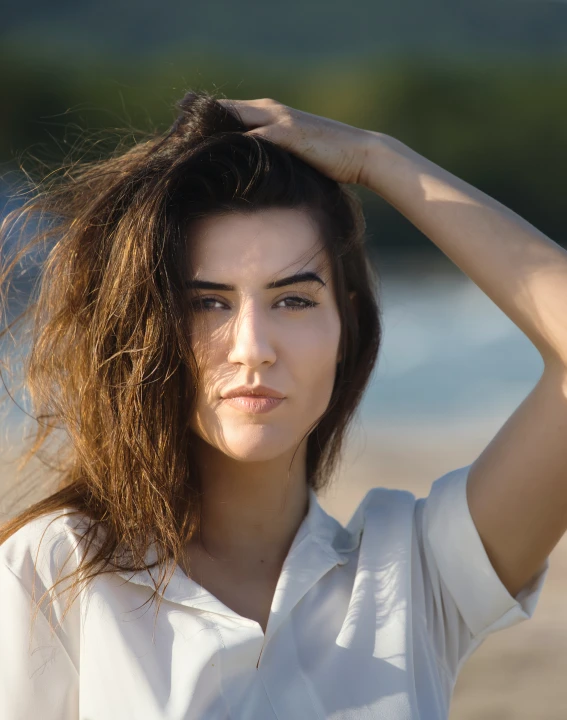 a beautiful woman with long brown hair on a beach