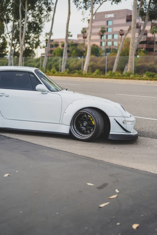 a white car sits parked in an empty lot