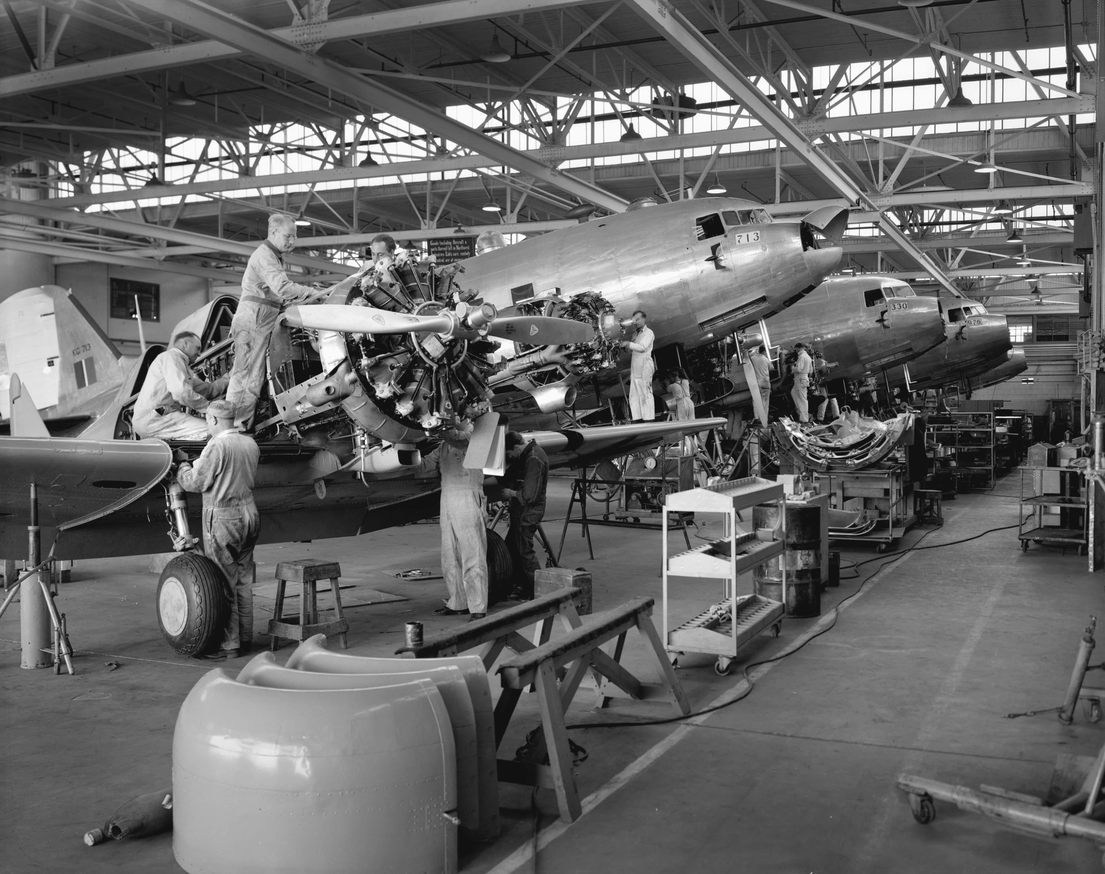 an airplane being worked on in a factory