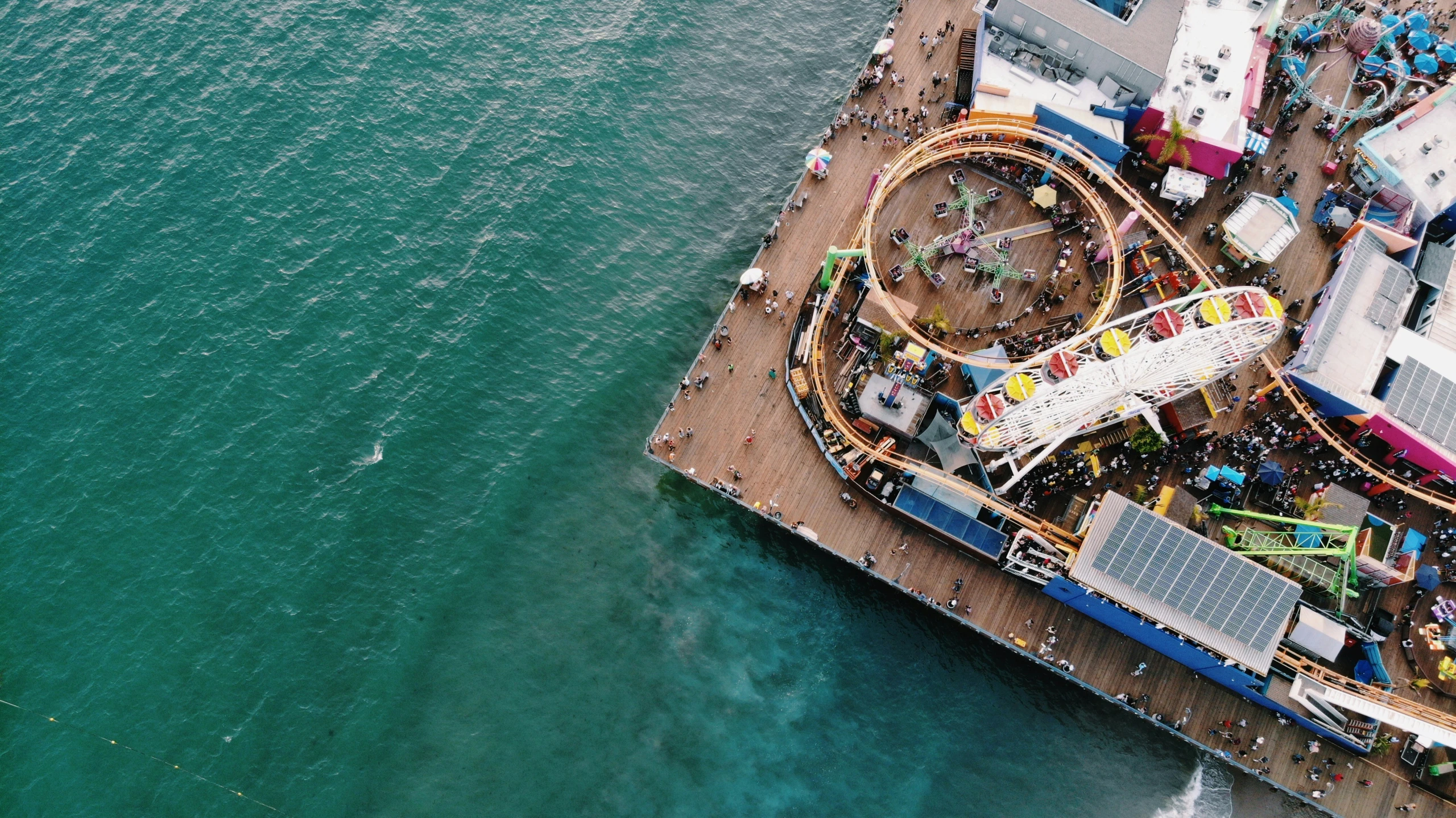 a carnival rides in an aerial view near the water