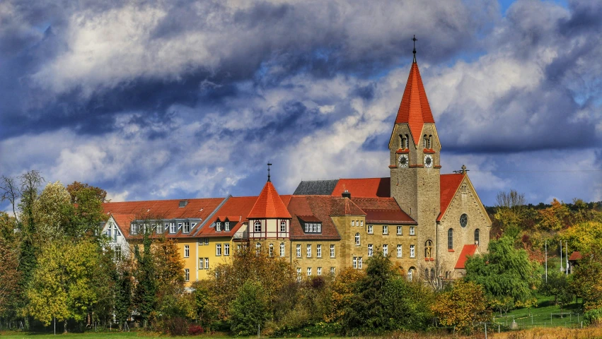 a building with orange roof and a tall clock tower