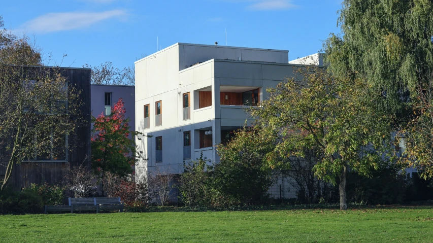 a building with trees in front of it in a yard