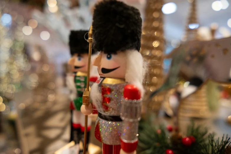 a toy soldier stands in front of a christmas tree