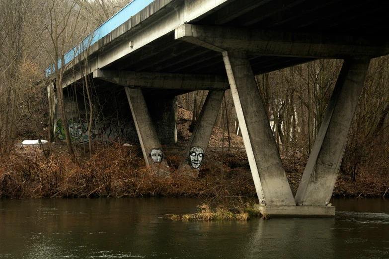 a large bridge that has a graffiti painting on it