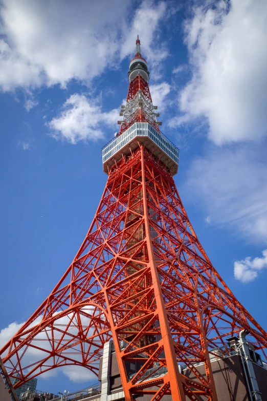 a tall tower with orange platforms under a blue sky