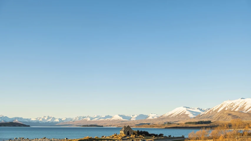 a view of snow capped mountains and a body of water