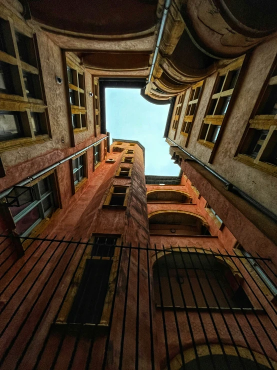 looking up at an old building with several windows