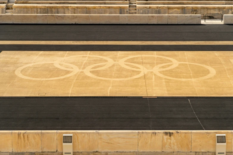 a large sign for the olympic games on the side of a road