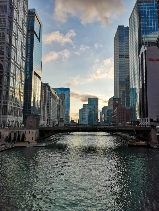 a view of a bridge that crosses the water next to several other buildings