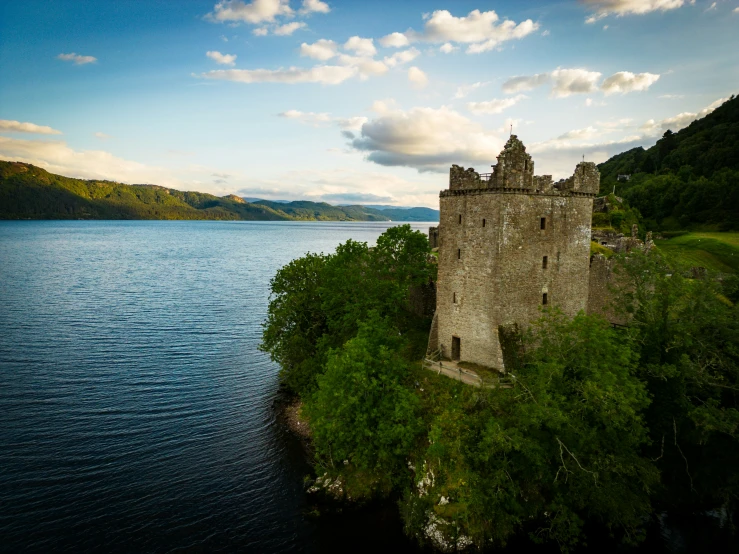 a castle is on an island with green trees