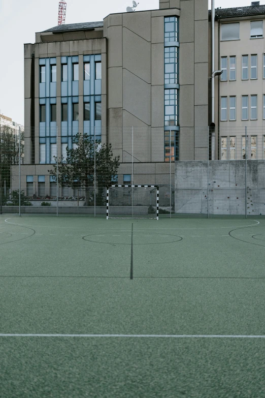 a soccer goal stands on a city field