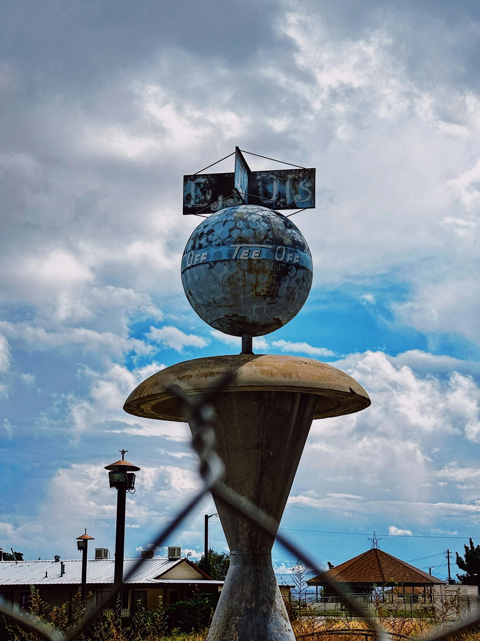 an object sitting on top of a fountain in the middle of a field