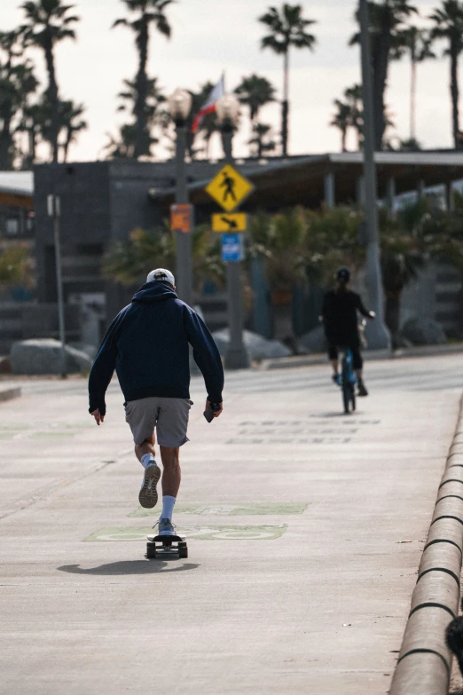 a man riding his skateboard down the road